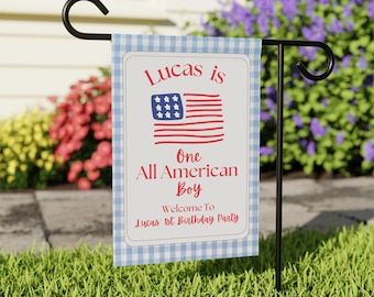 May include: A garden flag with a blue and white gingham border. The flag features the text "Lucas is One All American Boy" with an American flag graphic. The bottom of the flag reads "Welcome To Lucas' 1st Birthday Party".
