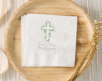 May include: White paper napkin with a watercolor illustration of a white cross surrounded by green leaves. The text "God Bless" is written in cursive script, followed by "Michael David Smith" and the date "10.03.2023".