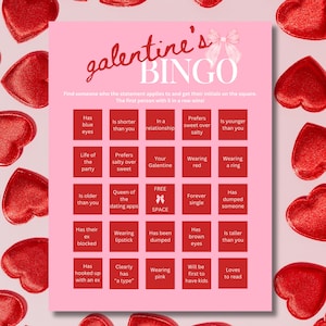 May include: Pink Galentine's Bingo card with a pink bow and hearts around the border. The card has 25 squares with different statements to find someone who matches. The free space is a pink bow.