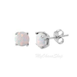 May include: A pair of silver stud earrings with white opal gemstones.