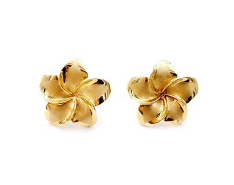 May include: A pair of gold flower-shaped stud earrings.