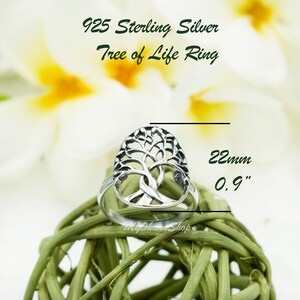 May include: A sterling silver Tree of Life ring. The ring has an openwork design of a tree with branches and roots. The ring is approximately 2.2 cm in length. The text "925 Sterling Silver Tree of Life Ring" is at the top.