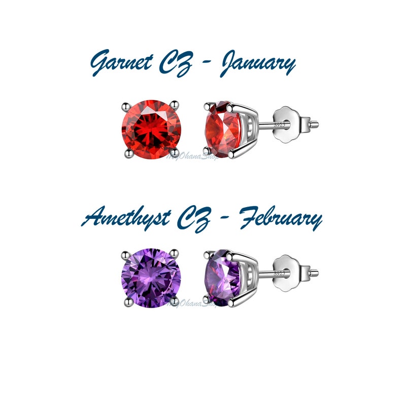 May include: Two pairs of silver stud earrings with red and purple cubic zirconia stones. The red stones are labeled "Garnet CZ - January" and the purple stones are labeled "Amethyst CZ - February".