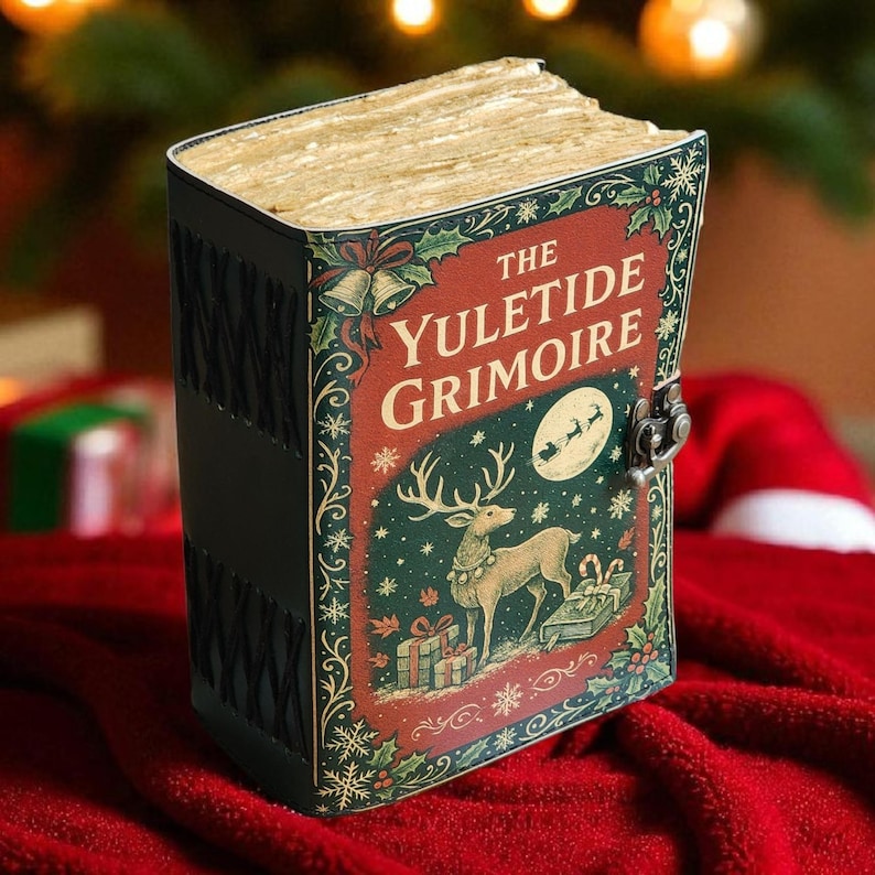 May include: A decorative book titled "The Yuletide Grimoire" with a Christmas theme. The cover features a reindeer, gifts, and Santa's sleigh under a full moon. The book has a metal clasp and is set against a red background.