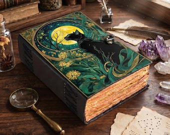 May include: A decorative journal with a black cat design on the cover, set against a moonlit night scene with green foliage. The journal has aged-looking pages and a metal clasp. A magnifying glass and crystals are nearby.