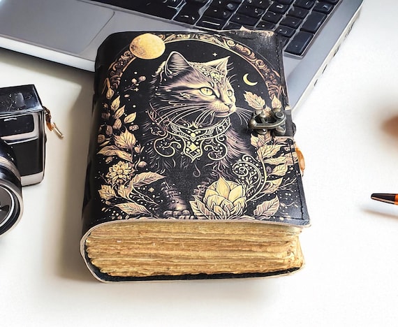 Mystical cat grimoire with deckle-edge paper and wiccan spell-book styling — 33 favorites at $44 says real buyers are finding and loving this specific piece.