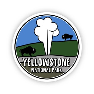 May include: A round sticker with a blue sky, green grass, and a white geyser erupting. Two black silhouettes of bison are walking on the grass. The text "Yellowstone National Park" is printed in white on a gray background.