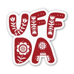 May include: A red and white sticker with the word "UFF DA" in a stylized font. The letters are red with white floral and dot patterns. The sticker has a white border.