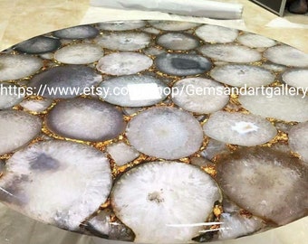 May include: A round table top made of white agate slices with gold leaf accents. The table top is approximately 30 inches in diameter.