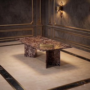 May include: A rectangular dining table crafted from dark brown marble with prominent white veining. The table features a thick, flat top supported by two vertical slab legs. A small gold plaque on the surface displays the text GemsAndArtGallery.