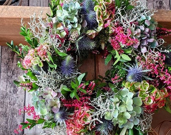 Autumn wreath of hydrangeas with thistles, table wreath with fresh hydrangeas, heather and autumnal greenery. door wreath