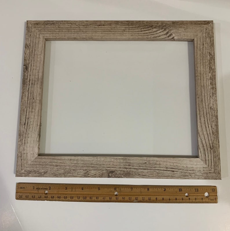 May include: A light wood picture frame with a white mat and a distressed finish. The frame measures 12 inches by 16 inches.