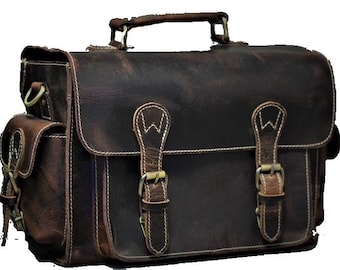 May include: A brown leather messenger bag with two front pockets and two adjustable straps with buckles. The bag has a top handle and a white stitching detail.