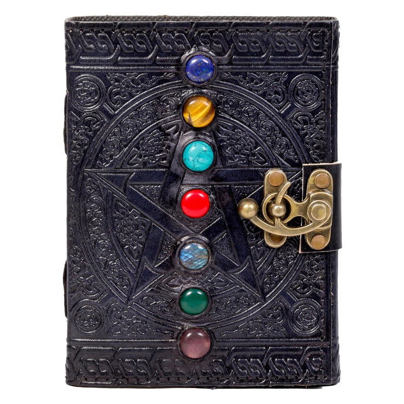 May include: Black leather journal with a pentagram design and seven colorful gemstones. The journal has a brass clasp.