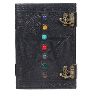 May include: Black leather journal with a pentagram design and seven colorful gemstones. The journal has two brass clasps.