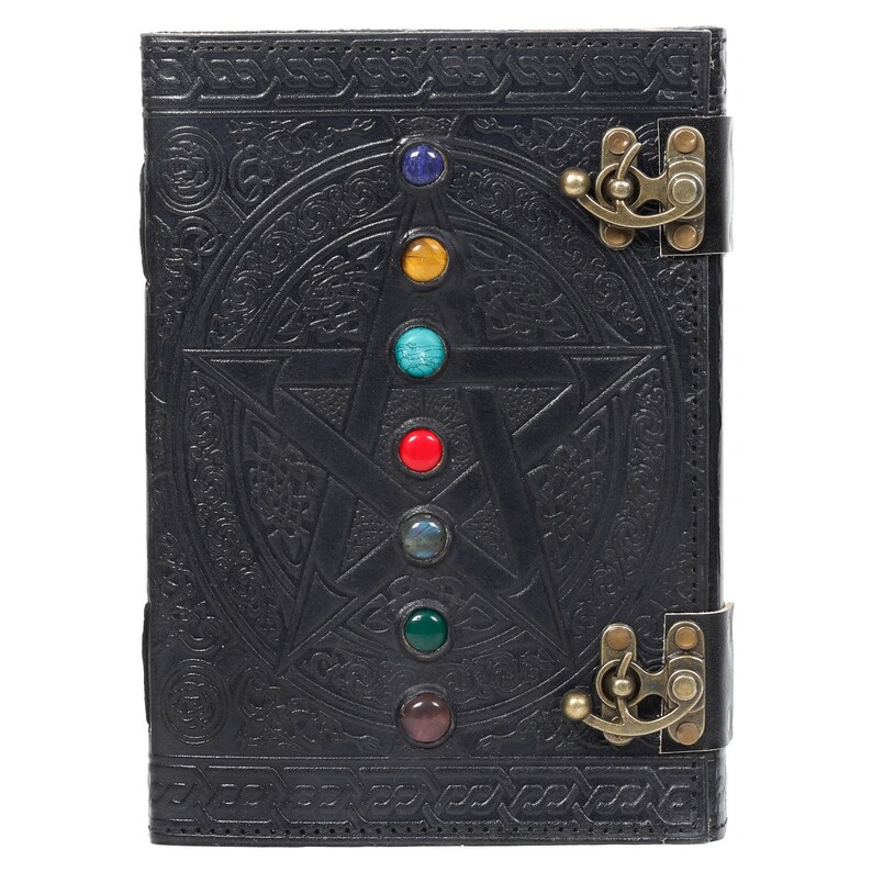 May include: Black leather journal with a pentagram design and seven colorful gemstones. The journal has two brass clasps.