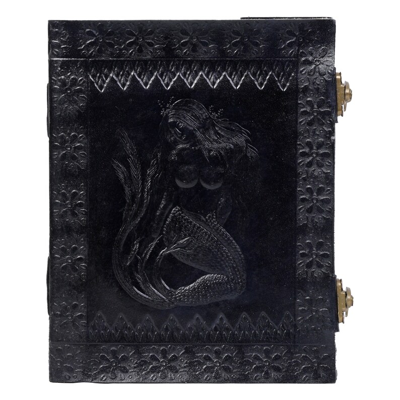 May include: Black leather journal with a mermaid embossed on the front cover. The journal has a decorative border and brass accents.