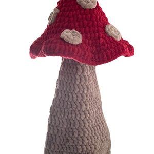 May include: A handmade mushroom bag holder, featuring a red cap with beige spots and a gray stem. The text "Mushroom Bag Holder" and "Pattern File Only" are visible. The Etsy shop name is also displayed.