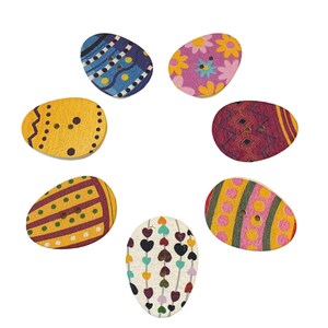 May include: Six wooden egg-shaped buttons with various colourful patterns, including hearts, polka dots, and geometric designs. Each button has two holes for sewing.
