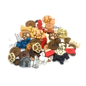 May include: A collection of assorted buttons featuring dog-themed shapes including paw prints, bones, fire hydrants, dog houses, and various dog breeds in colours of brown, red, white, black, and tan, with some standard round buttons mixed in.