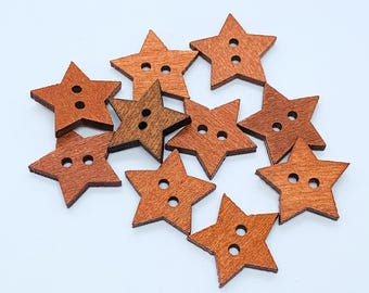 May include: Ten wooden star-shaped buttons in shades of brown. The buttons have two holes each.