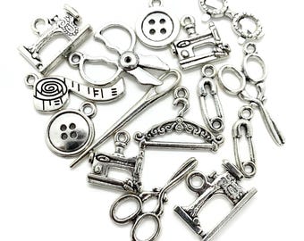May include: A selection of silver sewing charms, featuring sewing machines, scissors, buttons, measuring tape, needles, safety pins, and a clothes hanger. Perfect for crafting and jewellery making.