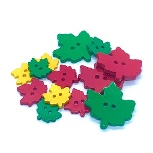 May include: Assortment of wooden leaf-shaped buttons in red, green, and yellow. Each button has two holes.