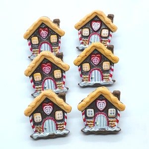 May include: Eight gingerbread house buttons with white icing and red candy hearts. The buttons are brown, white, and red.
