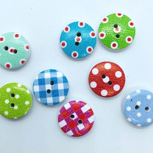 May include: Eight round wooden buttons with different colourful patterns. The patterns include polka dots, gingham, and checkered designs. The buttons are all approximately 2.5 cm in diameter.