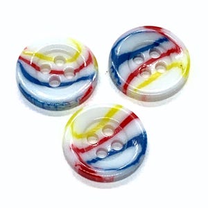 May include: Three round buttons with four holes. The buttons are white with red, yellow, and blue stripes. The stripes swirl around the button's surface, creating a marbled effect. These buttons are suitable for sewing and craft projects.