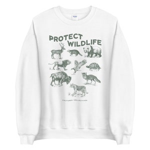 May include: White sweatshirt with a green graphic of various animals, including a deer, bear, and tiger. The words "PROTECT WILDLIFE" are printed above the animals. The brand name "CULTURED COLLECTIVES" is printed below the animals.