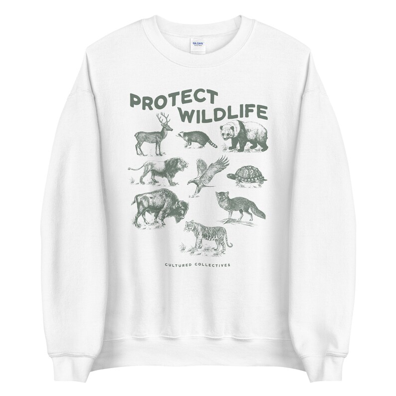 May include: White sweatshirt with a green graphic of various animals, including a deer, bear, and tiger. The words "PROTECT WILDLIFE" are printed above the animals. The brand name "CULTURED COLLECTIVES" is printed below the animals.