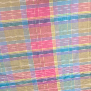May include: A multi-colored plaid fabric with a variety of shades of pink, blue, green, and yellow.