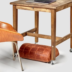 Ergonomic footrest leather accessory to any desk. Under desk foot rest for improved posture, and orthopedic relief
