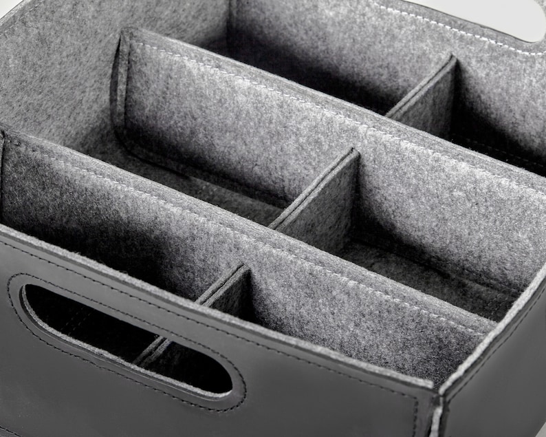 May include: Black leather storage box with a gray felt interior divided into multiple compartments.