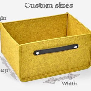 May include: A yellow felt storage box with a black leather handle. The box is labeled with the words "Height", "Deep", and "Width" to indicate the dimensions.