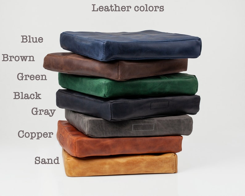 May include: A stack of eight leather cushions in different colors, including blue, brown, green, black, gray, copper, and sand.