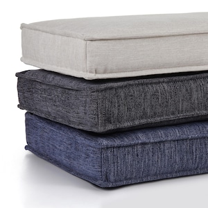 May include: Three rectangular cushions stacked on top of each other. The top cushion is light gray, the middle cushion is dark gray, and the bottom cushion is navy blue. Each cushion has a stitched border.