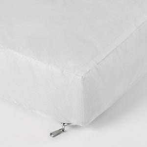 May include: White cushion with a zipper closure.