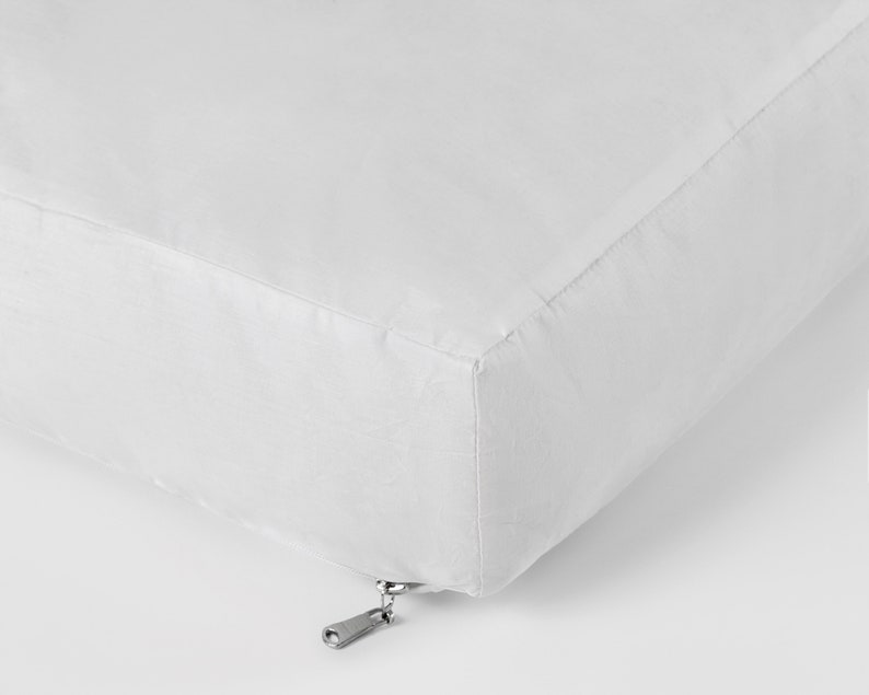 May include: White cushion with a zipper closure.