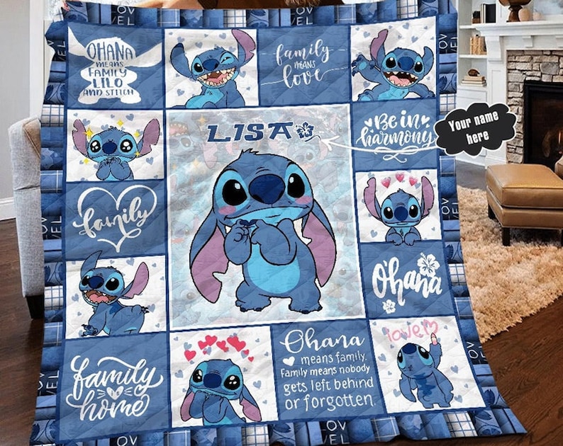 May include: A blue and white quilt with a patchwork design featuring Stitch characters from the Disney movie Lilo & Stitch. The quilt has various phrases including "Ohana means family", "Family means love", "Be in harmony", and "Family home".