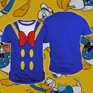 A blue t-shirt with a cartoon duck design, featuring a red bow tie and yellow duck-like shapes on the front.
