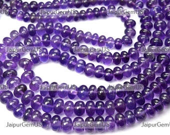 May include: Strands of polished, deep purple amethyst beads. The beads are smooth, rounded, and vary slightly in size, strung together to create a necklace or bracelet. The image is well-lit, showcasing the natural color and clarity of the gemstones.