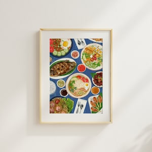 May include: Framed art print with a vibrant illustration of diverse dishes on a blue tablecloth. The artwork depicts noodles, grilled fish, and salads. The print is presented in a light wooden frame, suitable for kitchen or dining room decor.