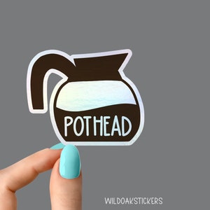 May include: A holographic sticker of a coffee pot with the text "POTHEAD" in white lettering.