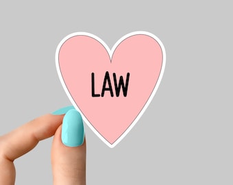 May include: A pink heart-shaped sticker with the word "LAW" printed in black.