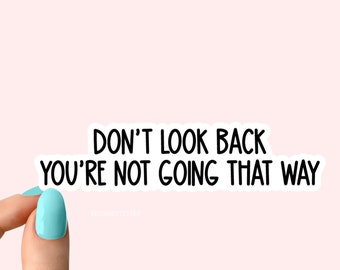 May include: A white sticker with black text that reads "Don't look back you're not going that way".
