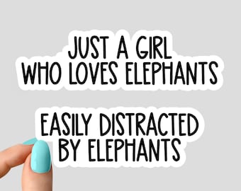 May include: Two white stickers with black text. The top sticker says "Just a girl who loves elephants". The bottom sticker says "Easily distracted by elephants".