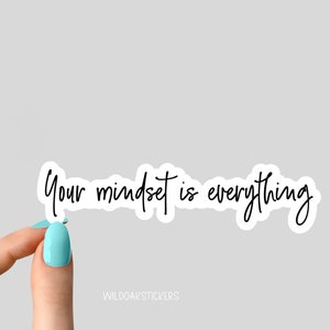 Puede incluir: Pegatina blanca con texto en cursiva negra que dice "Your mindset is everything".