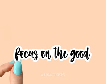 May include: White sticker with black cursive text that reads "focus on the good".